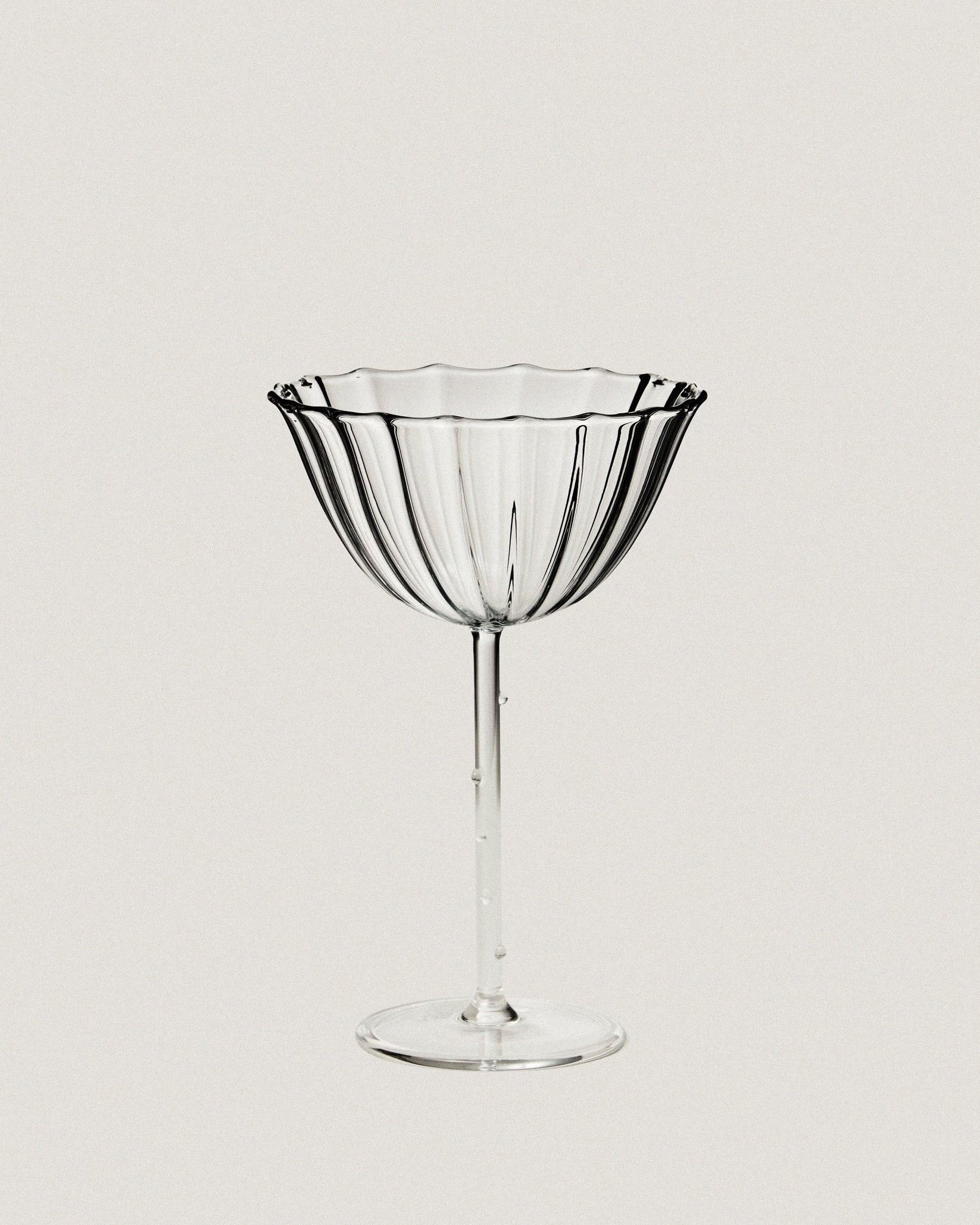 Fluted coupe glass with scalloped rim
