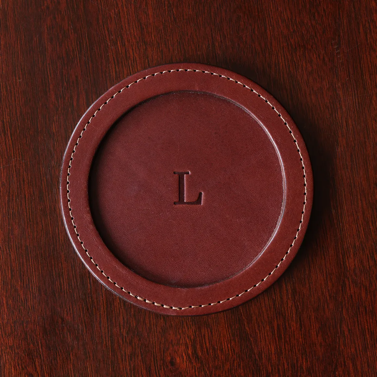 Round leather coaster with monogram