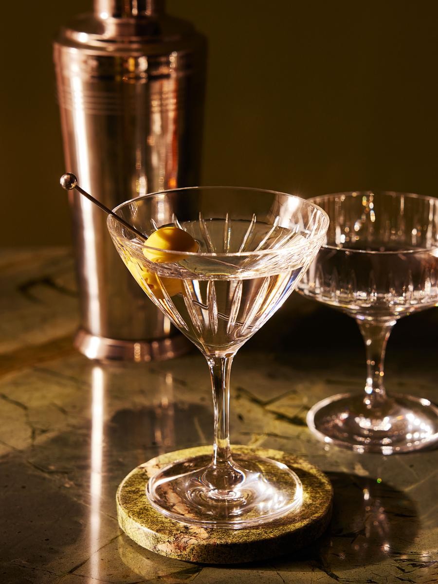 Martini with olive, silver shaker and stone coaster